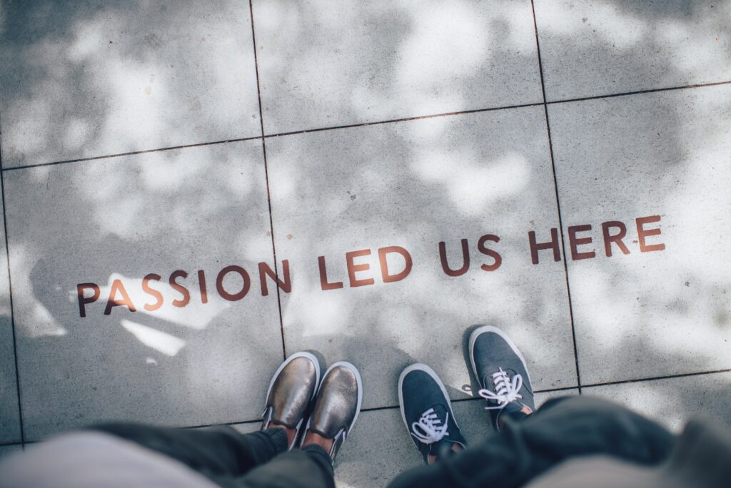 The point of view is two people looking down on the statement Passion Led Us Here.